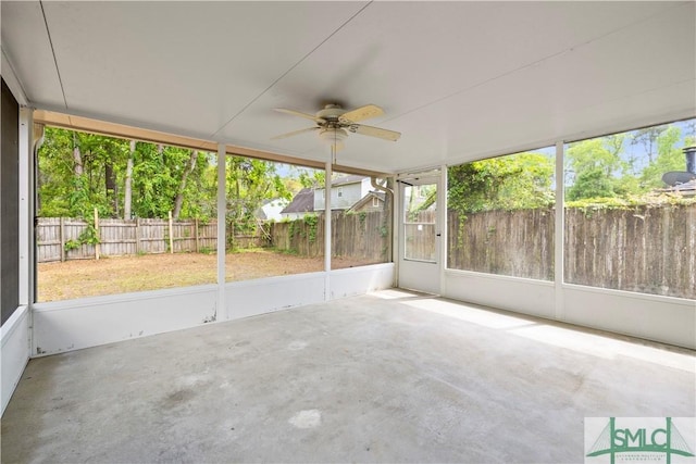 unfurnished sunroom with a ceiling fan