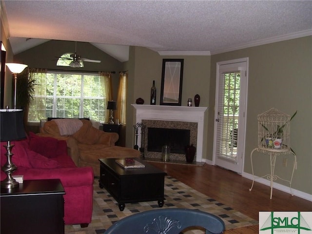 living room featuring a wealth of natural light, wood finished floors, and a textured ceiling