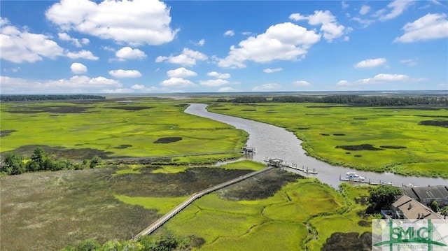 birds eye view of property featuring a water view and a rural view