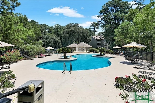 pool featuring a patio area and fence