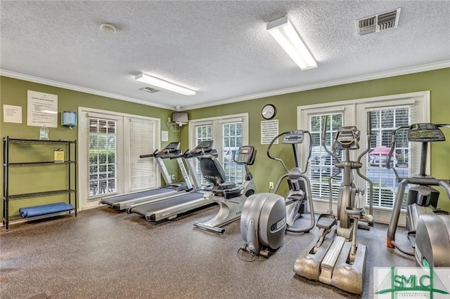 exercise room featuring visible vents, a textured ceiling, and ornamental molding