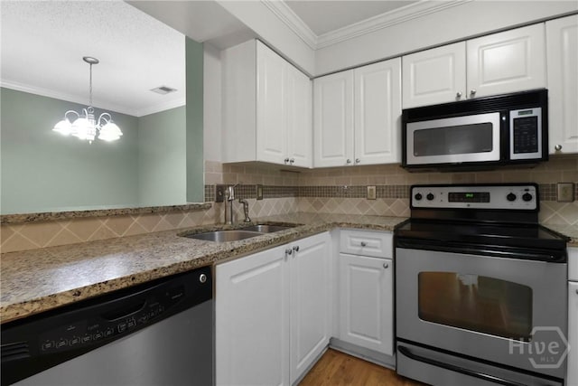 12300 Apache Ave Unit 1212, Savannah, GA 31419 - kitchen featuring stainless steel appliances, a sink, a chandelier, ornamental molding, and white cabinetry
