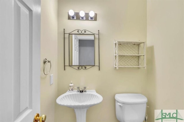 half bathroom with a sink and toilet
