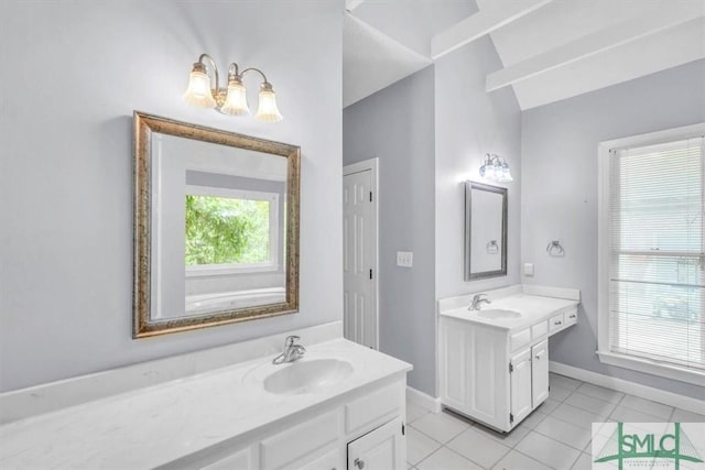full bathroom with two vanities, tile patterned floors, baseboards, and a sink