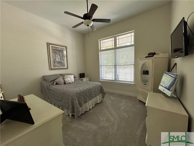 carpeted bedroom featuring a ceiling fan and baseboards