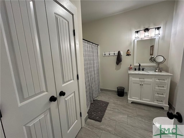 full bathroom with vanity, marble finish floor, baseboards, and a shower with curtain