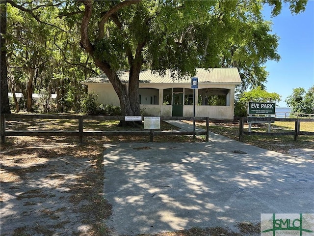 view of front of house with fence and metal roof