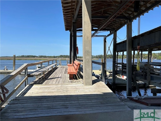 view of dock with boat lift and a water view