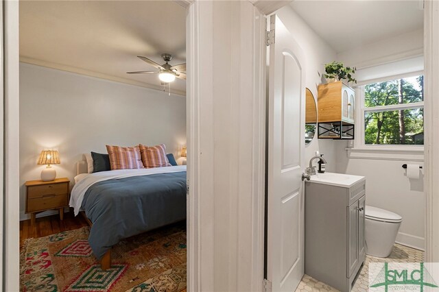 bedroom featuring ceiling fan and a sink