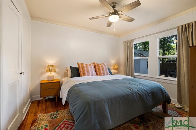 bedroom with ceiling fan, baseboards, ornamental molding, and wood finished floors
