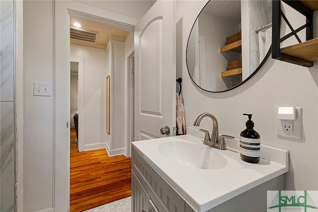 bathroom featuring vanity, wood finished floors, and visible vents