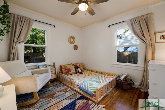 bedroom with a ceiling fan, baseboards, ornamental molding, and wood-type flooring