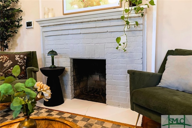 interior details featuring a brick fireplace
