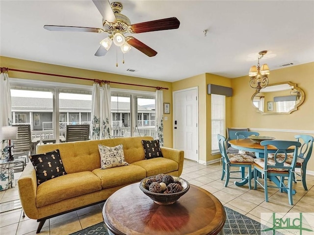 2 17th St Unit H 8, Tybee Island, GA 31328 - living area with light tile patterned flooring, baseboards, a ceiling fan, and a chandelier