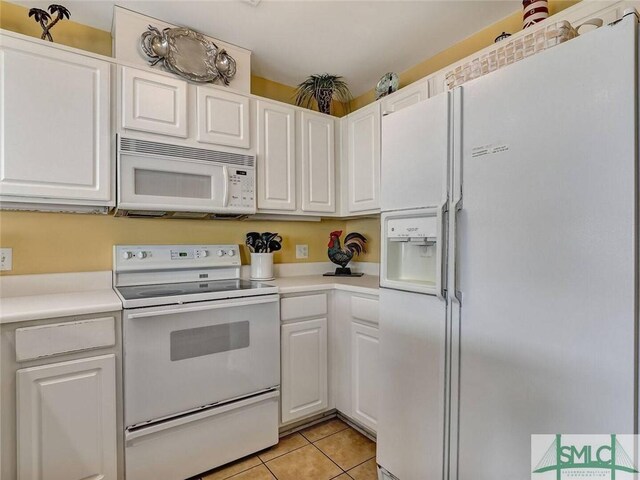 2 17th St Unit H 8, Tybee Island, GA 31328 - kitchen with white appliances, light tile patterned flooring, light countertops, and white cabinetry