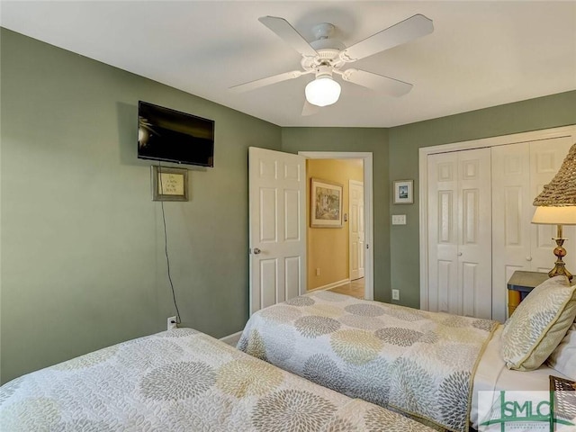 carpeted bedroom with baseboards, a closet, and ceiling fan
