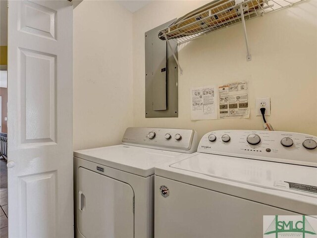 laundry area with washing machine and dryer, electric panel, and laundry area