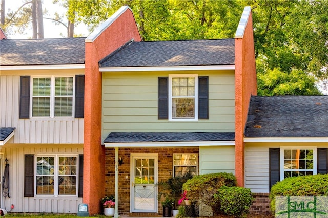 view of front of property with roof with shingles and board and batten siding