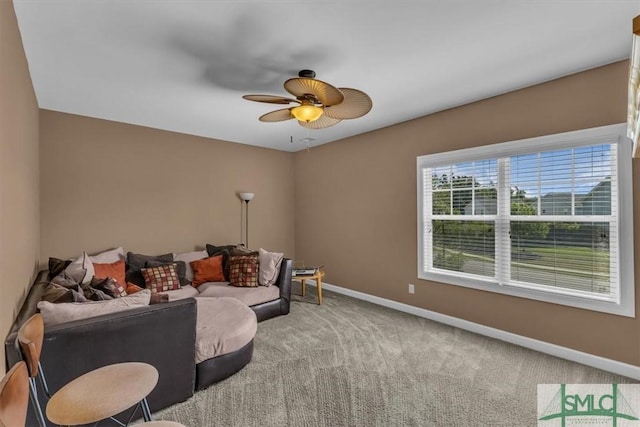 living room featuring baseboards, carpet floors, and ceiling fan