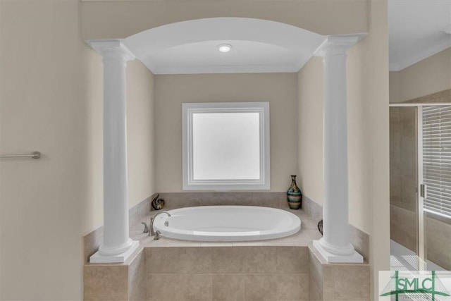 bathroom featuring a garden tub, a shower stall, and ornate columns