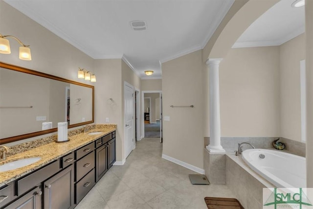bathroom with double vanity, a garden tub, a sink, and ornate columns