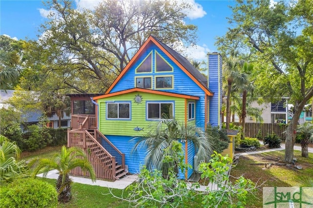 12 Carpenter Rd, Tybee Island, GA 31328 - rear view of house featuring stairs and a chimney