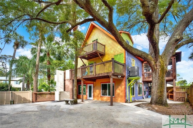 12 Carpenter Rd, Tybee Island, GA 31328 - rear view of house with a balcony and a gate