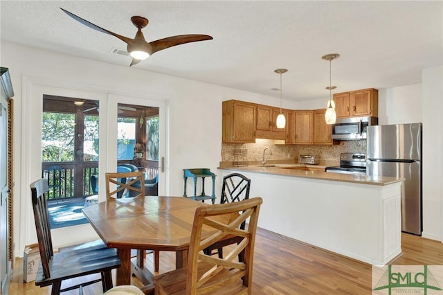 12 Carpenter Rd, Tybee Island, GA 31328 - dining space with ceiling fan, light wood finished floors, and french doors