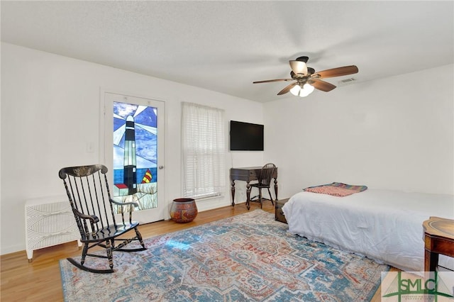 12 Carpenter Rd, Tybee Island, GA 31328 - bedroom featuring access to exterior, wood finished floors, and a ceiling fan