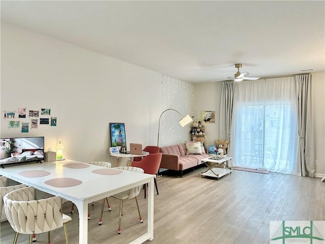 dining area with a ceiling fan and wood finished floors