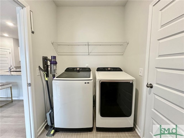 laundry area featuring laundry area, baseboards, and washer and dryer