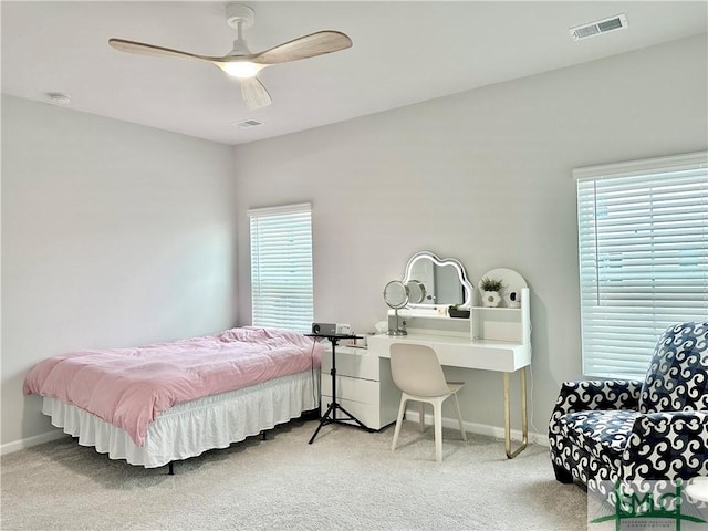bedroom with carpet floors, baseboards, ceiling fan, and visible vents