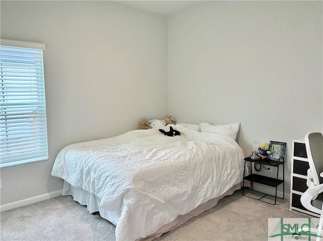 carpeted bedroom with baseboards and multiple windows