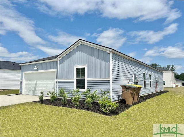 view of home's exterior featuring a lawn, board and batten siding, and driveway