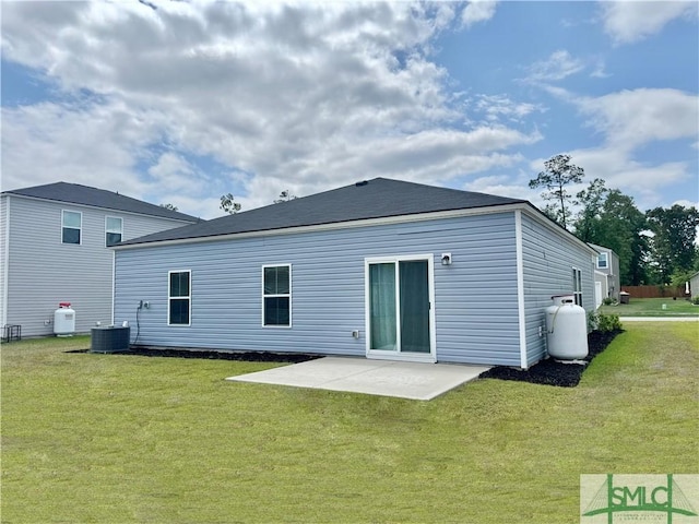 back of property with a yard and a patio area