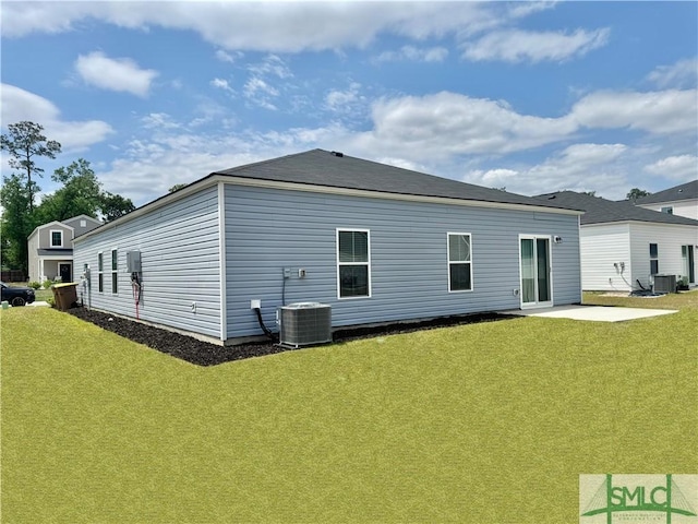 back of property featuring a yard, central AC unit, and a patio area