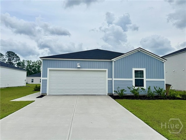 262 Lillian St, Rincon, GA 31326 - view of front of property featuring concrete driveway, a front yard, a garage, and board and batten siding