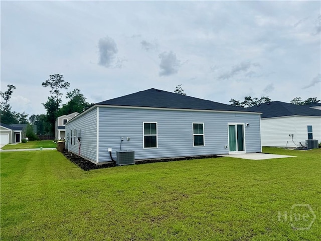 262 Lillian St, Rincon, GA 31326 - rear view of property with central AC unit, a lawn, and a patio