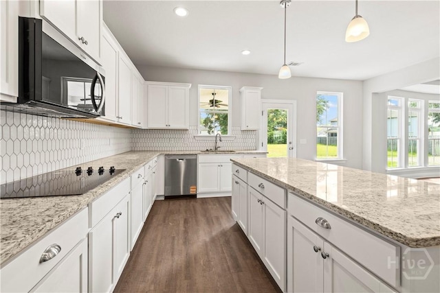 31 Oakmont Dr, Guyton, GA 31312 - kitchen with stainless steel appliances, dark wood-style floors, decorative backsplash, white cabinets, and pendant lighting