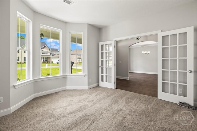 31 Oakmont Dr, Guyton, GA 31312 - carpeted empty room with a chandelier and french doors