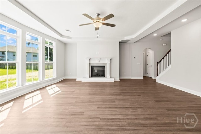 31 Oakmont Dr, Guyton, GA 31312 - unfurnished living room with a raised ceiling, arched walkways, healthy amount of natural light, a ceiling fan, and recessed lighting
