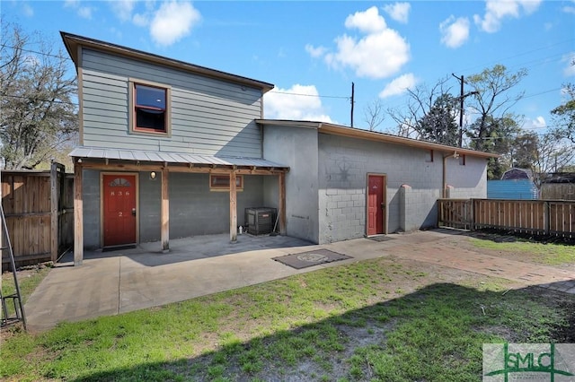 836 E Park Ave, Savannah, GA 31401 - rear view of house with a patio, metal roof, central air condition unit, and a standing seam roof