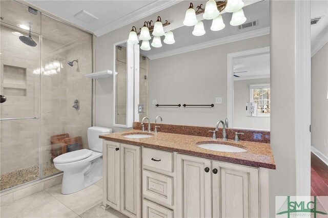 836 E Park Ave, Savannah, GA 31401 - bathroom featuring ornamental molding, a stall shower, double vanity, toilet, and tile patterned floors