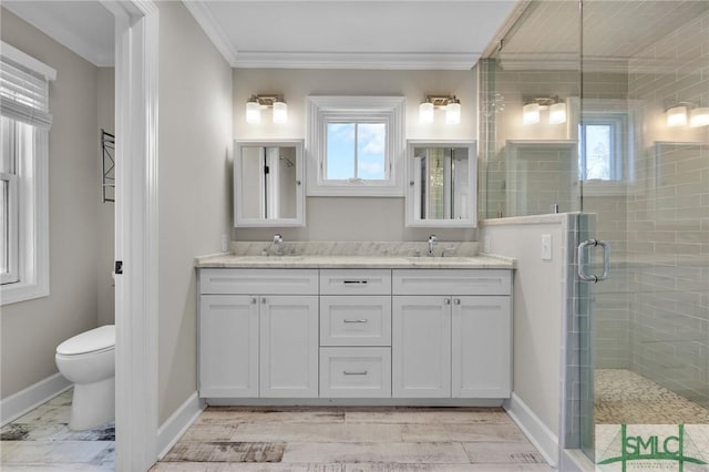 836 E Park Ave, Savannah, GA 31401 - bathroom featuring plenty of natural light, double vanity, a shower stall, toilet, and crown molding