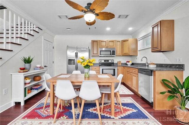836 E Park Ave, Savannah, GA 31401 - kitchen with appliances with stainless steel finishes, a sink, dark wood finished floors, a ceiling fan, and dark countertops