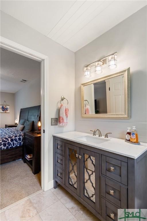 ensuite bathroom with ensuite bath and vanity