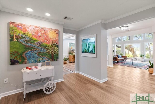 interior space featuring baseboards, wood finished floors, and visible vents