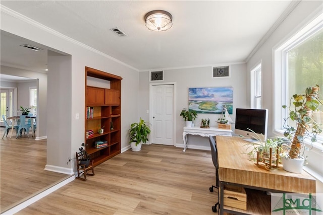 home office featuring crown molding, visible vents, and light wood finished floors