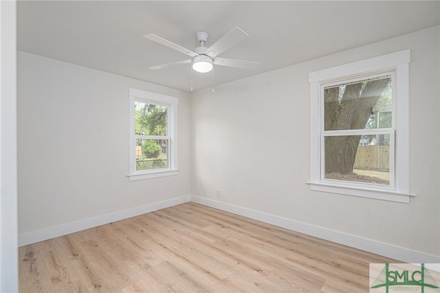empty room featuring baseboards, a ceiling fan, and wood finished floors