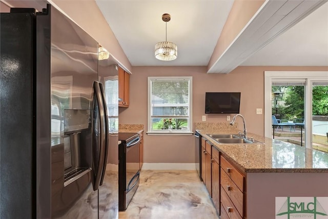 512 Winwood Pl, Savannah, GA 31419 - kitchen featuring stainless steel appliances, a sink, brown cabinetry, baseboards, and a peninsula